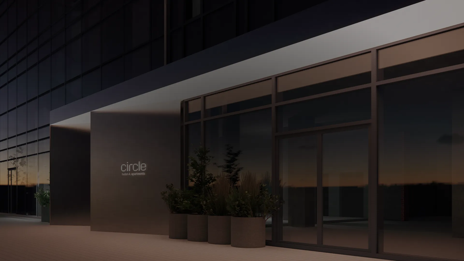 Фасад сучасної будівлі з логотипом Circle (hotel & apartments), великими прозорими вікнами, металевим каркасом, рослинами у горщиках на терасі та вечірнім освітленням.
