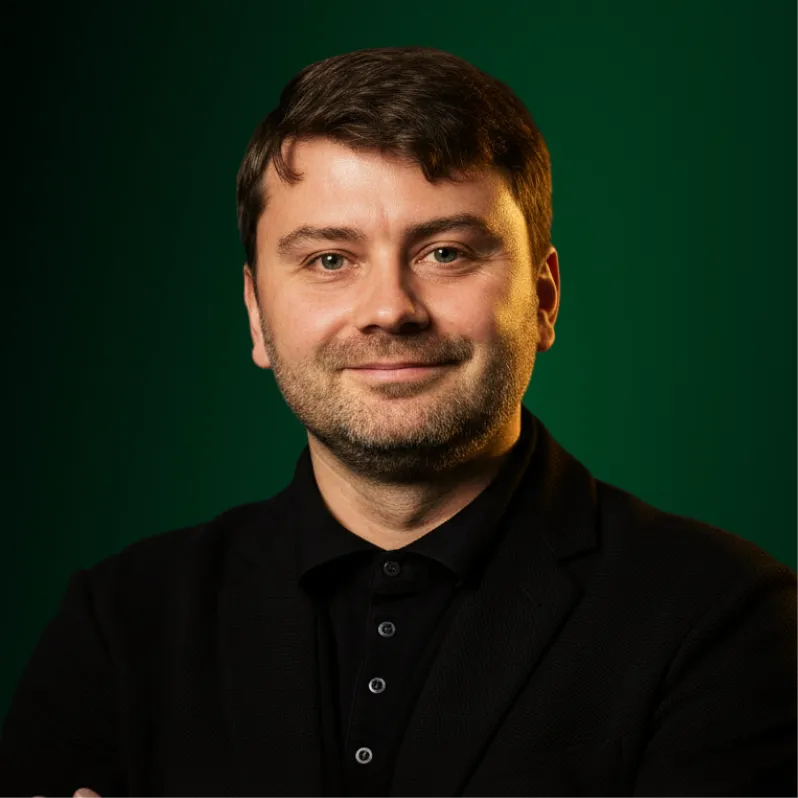 A portrait of Vitalii Gorovyi against a green background.